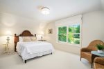 Upper level queen bedroom overlooking the nature out the back of the home 
